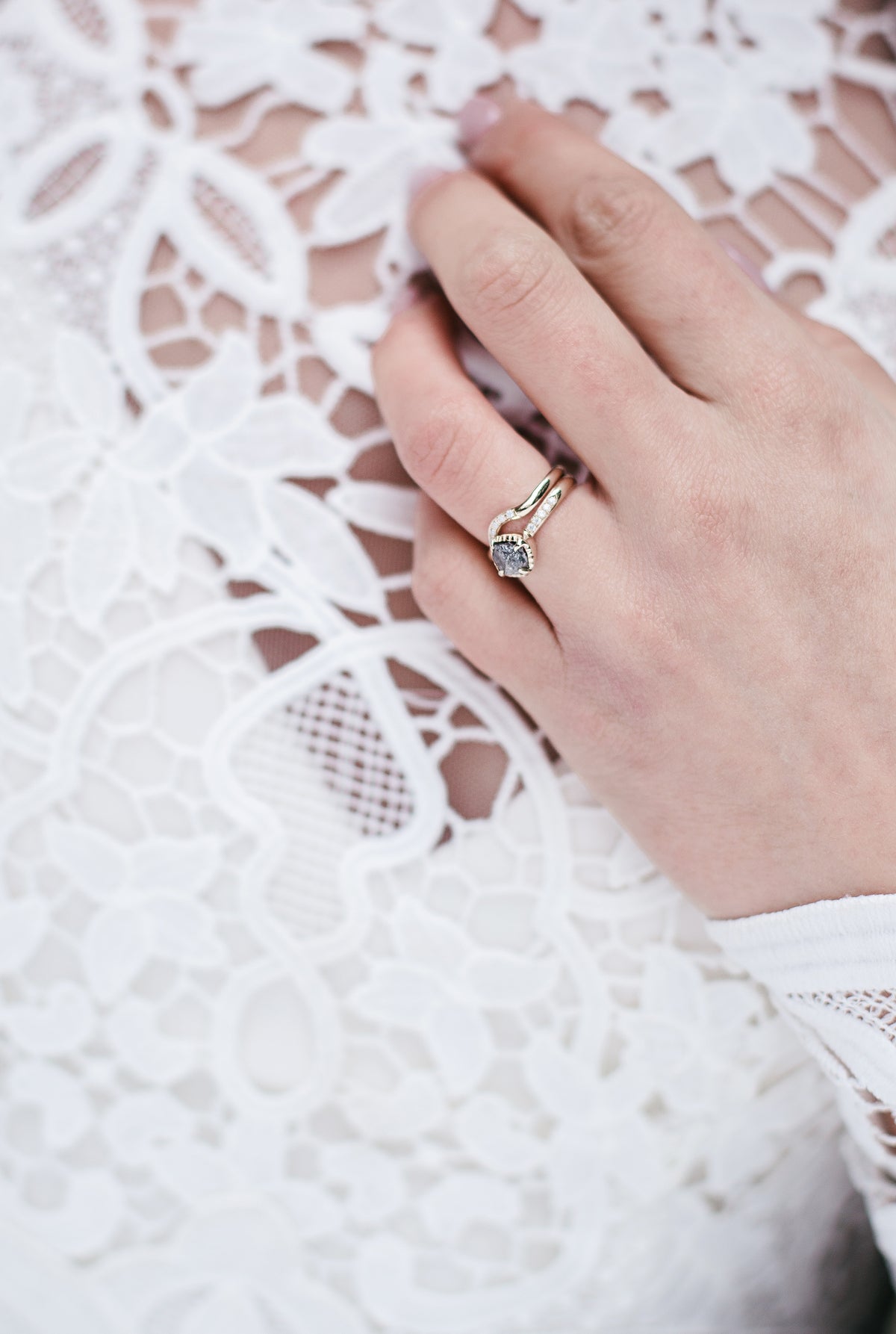 A close up of the brides wedding ring and band